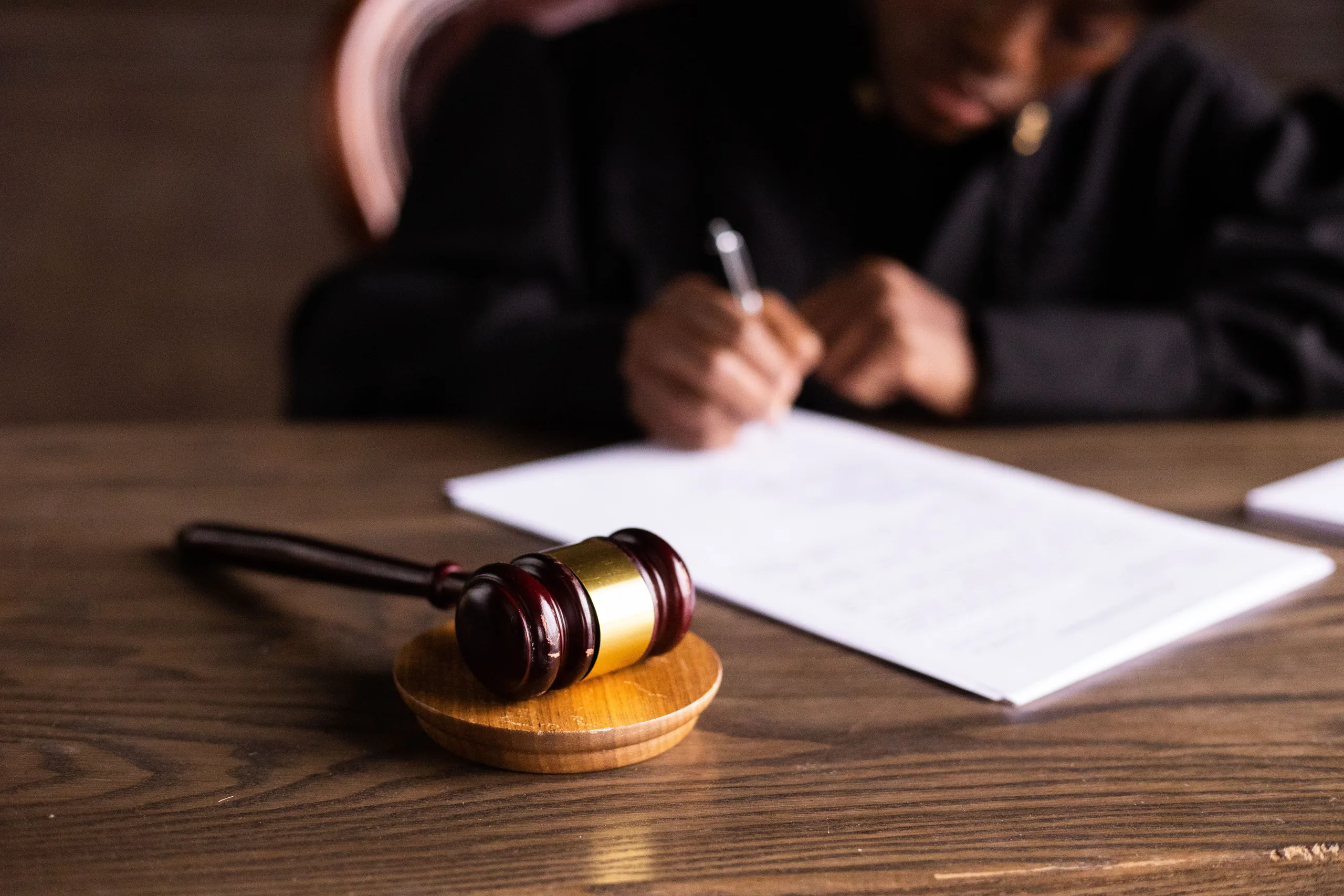 A judge gavel resting on court documents, illustrating the Trump University class action settlement