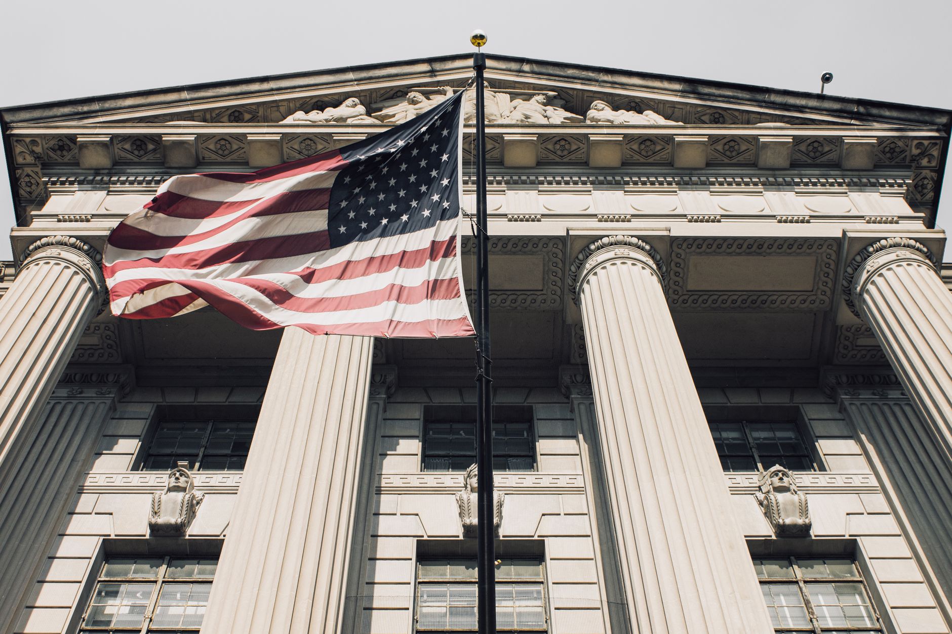 Majestic view of a government building with the American flag waving proudly.
