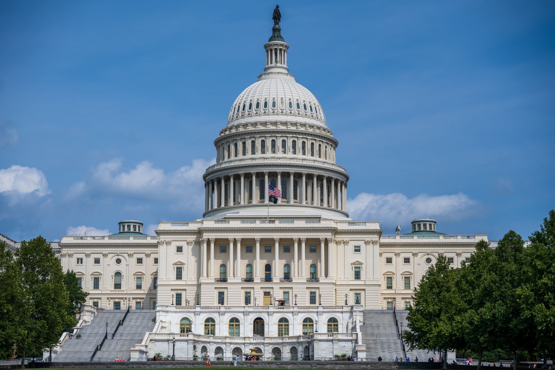 U.S. Capitol under a blue sky with clouds