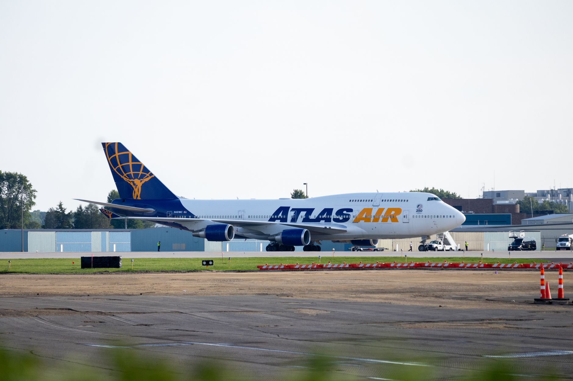 Atlas Air Boeing 747 cargo plane parked on the airport runway during daylight.