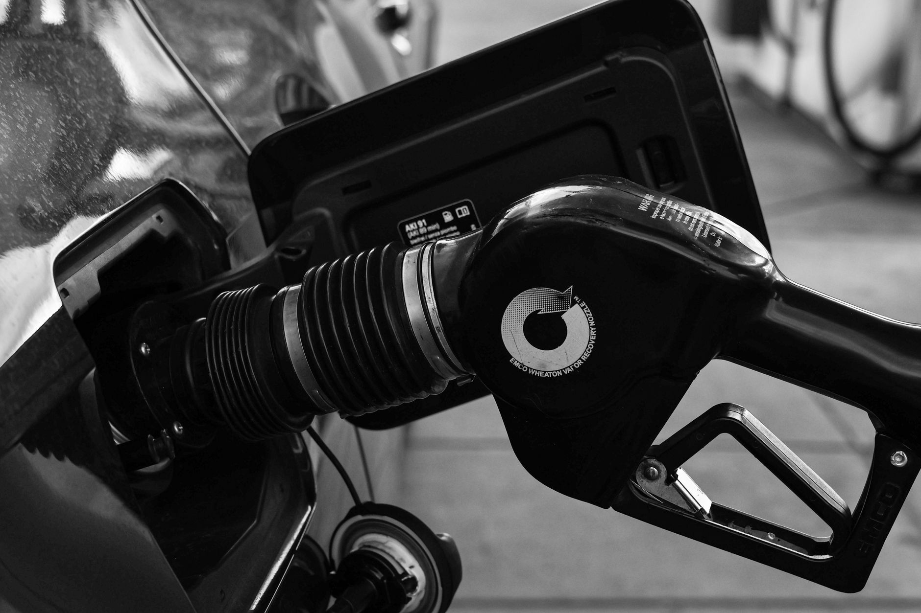 Black-and-white close-up of a fuel pump nozzle
