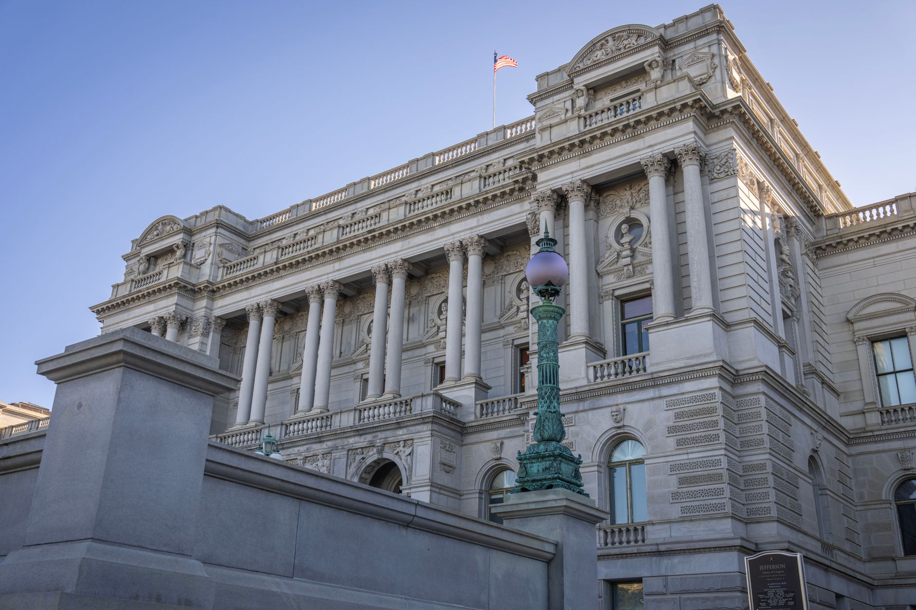 A view of the historic Library of Congress building with detailed architectural features under clear blue sky.