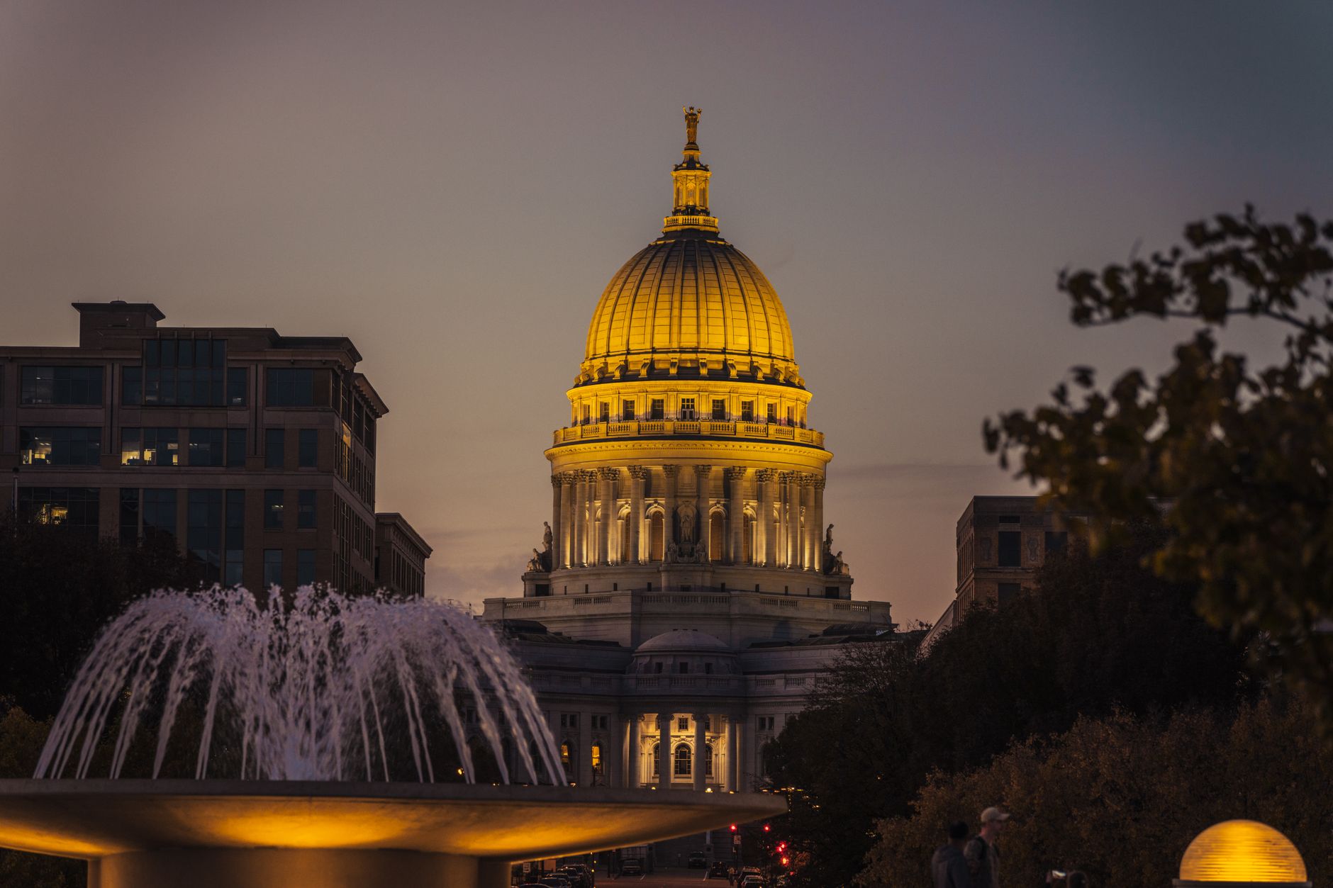 The Wisconsin State Capitol illuminated during twilight, showcasing its architectural beauty.