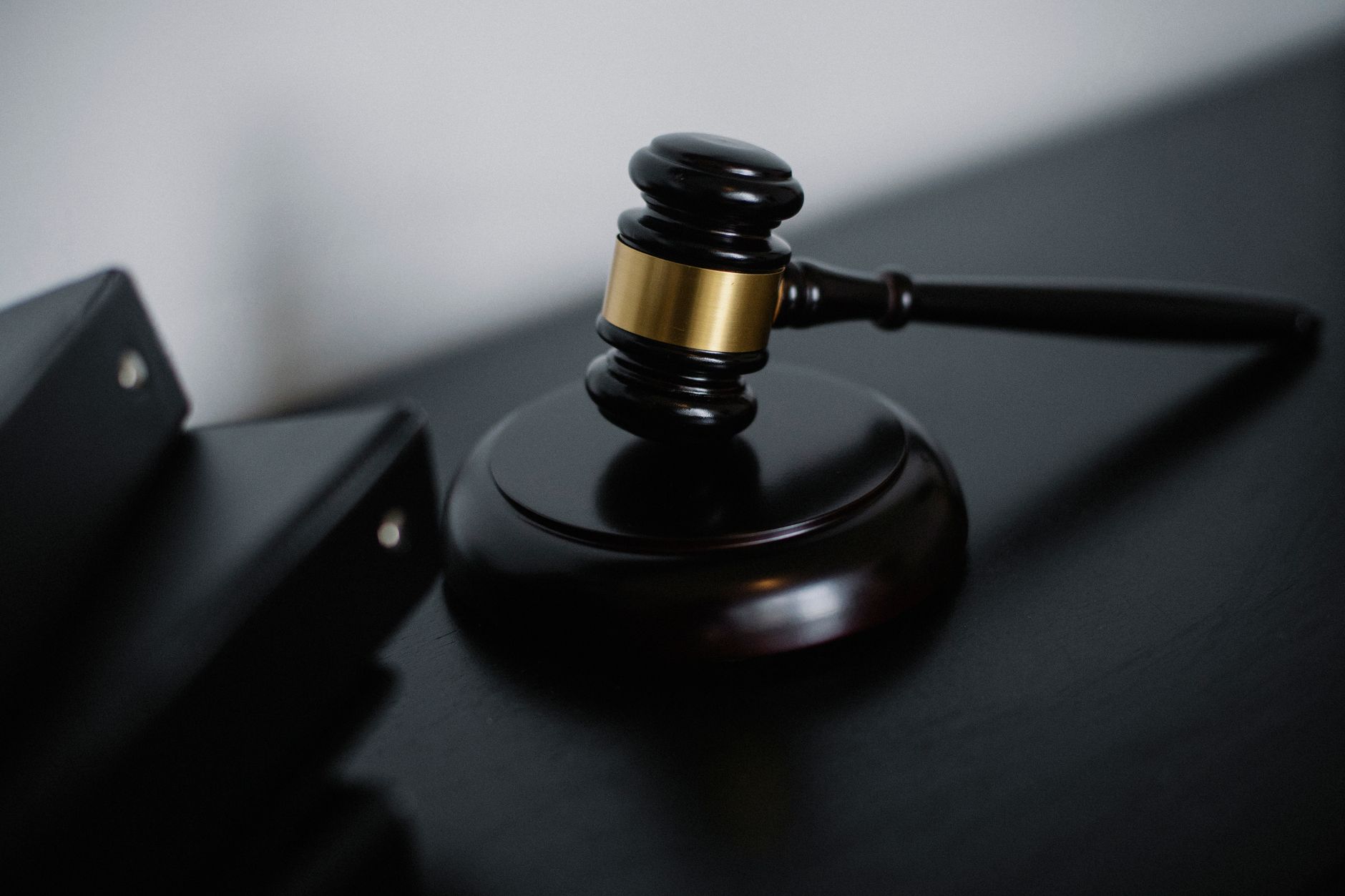 Judge's gavel resting on a dark desk