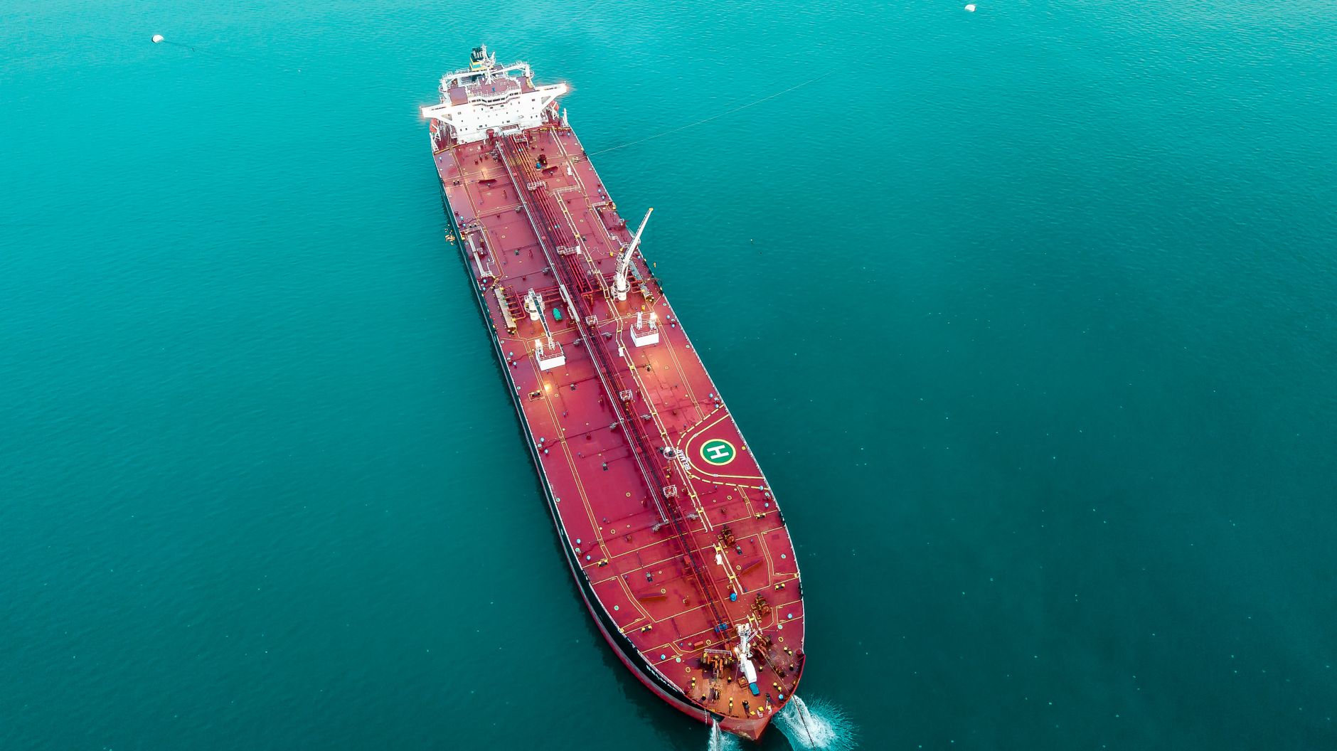 Aerial view of a red oil tanker at sea