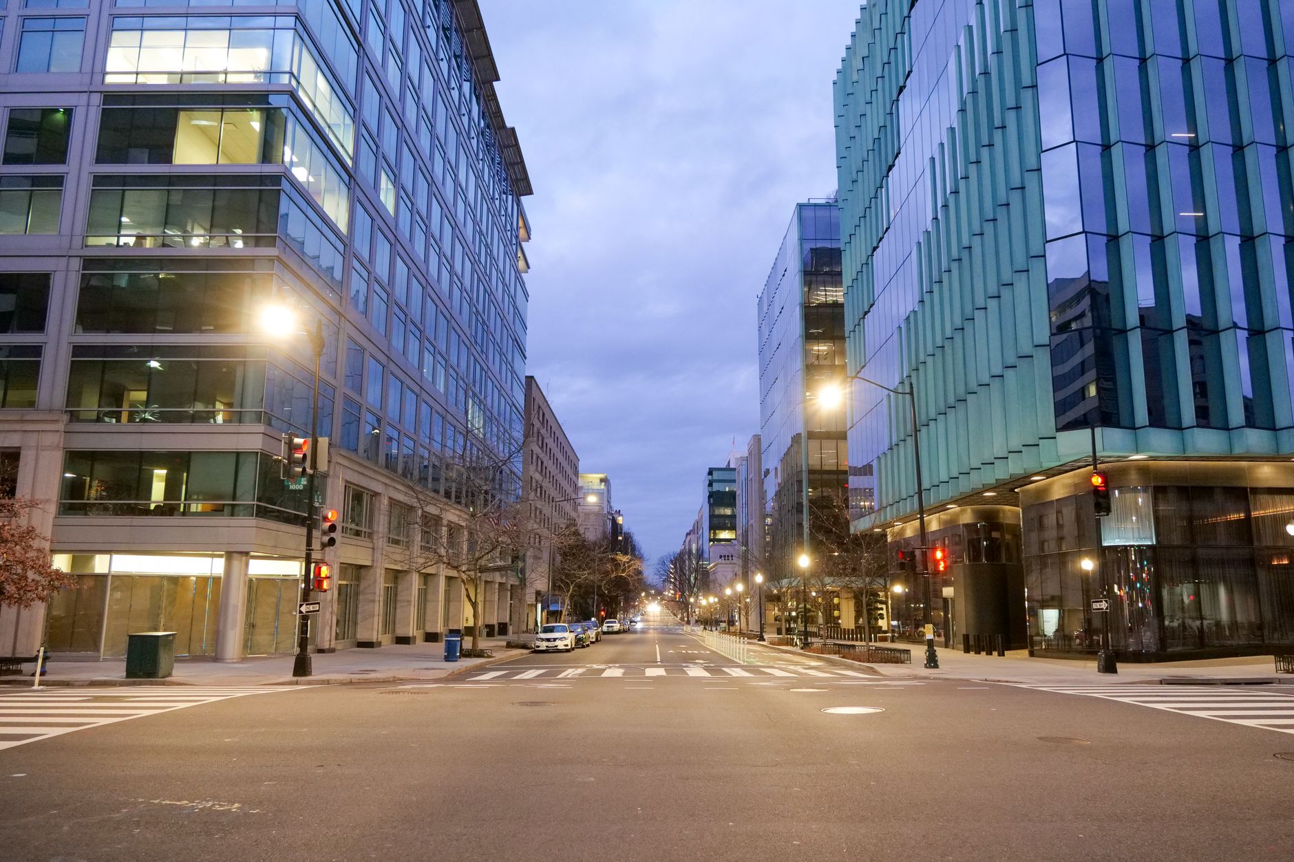 Empty street in Washington DC with modern buildings at dawn, showcasing urban architecture and tranquility.