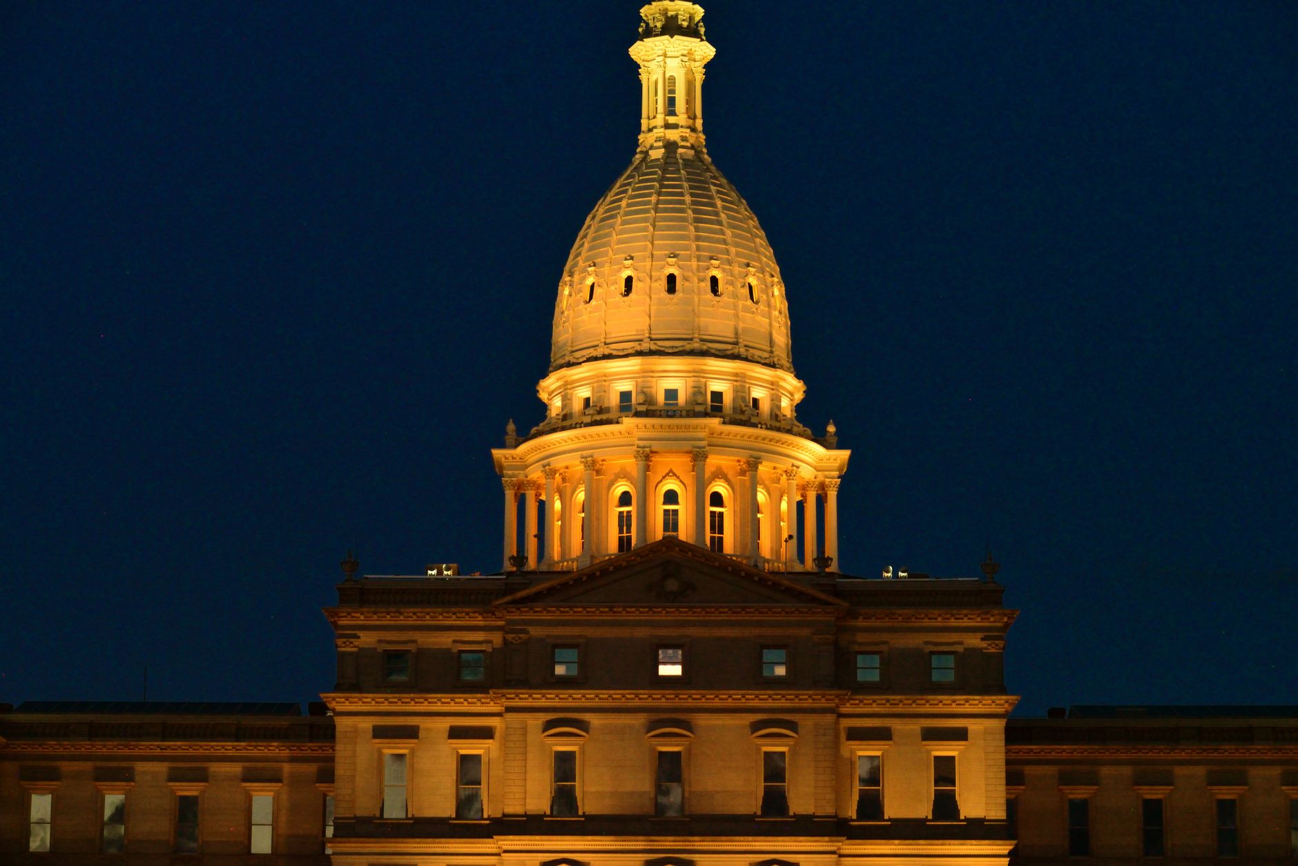 Night view of the beautifully lit Michigan State Capitol in Lansing, highlighting its architectural splendor.