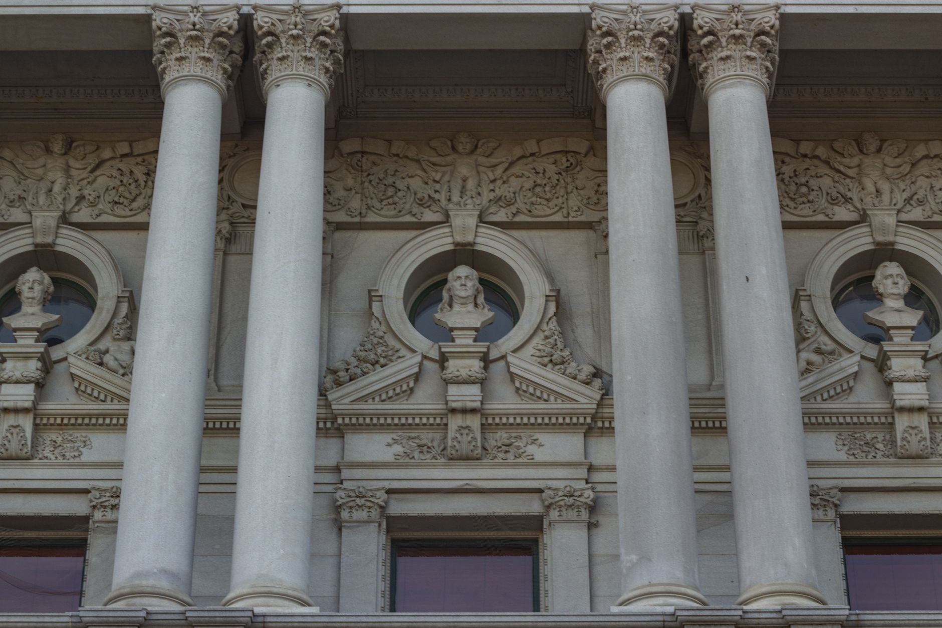 Detailed view of classic architecture with sculptures and columns at a historic library.