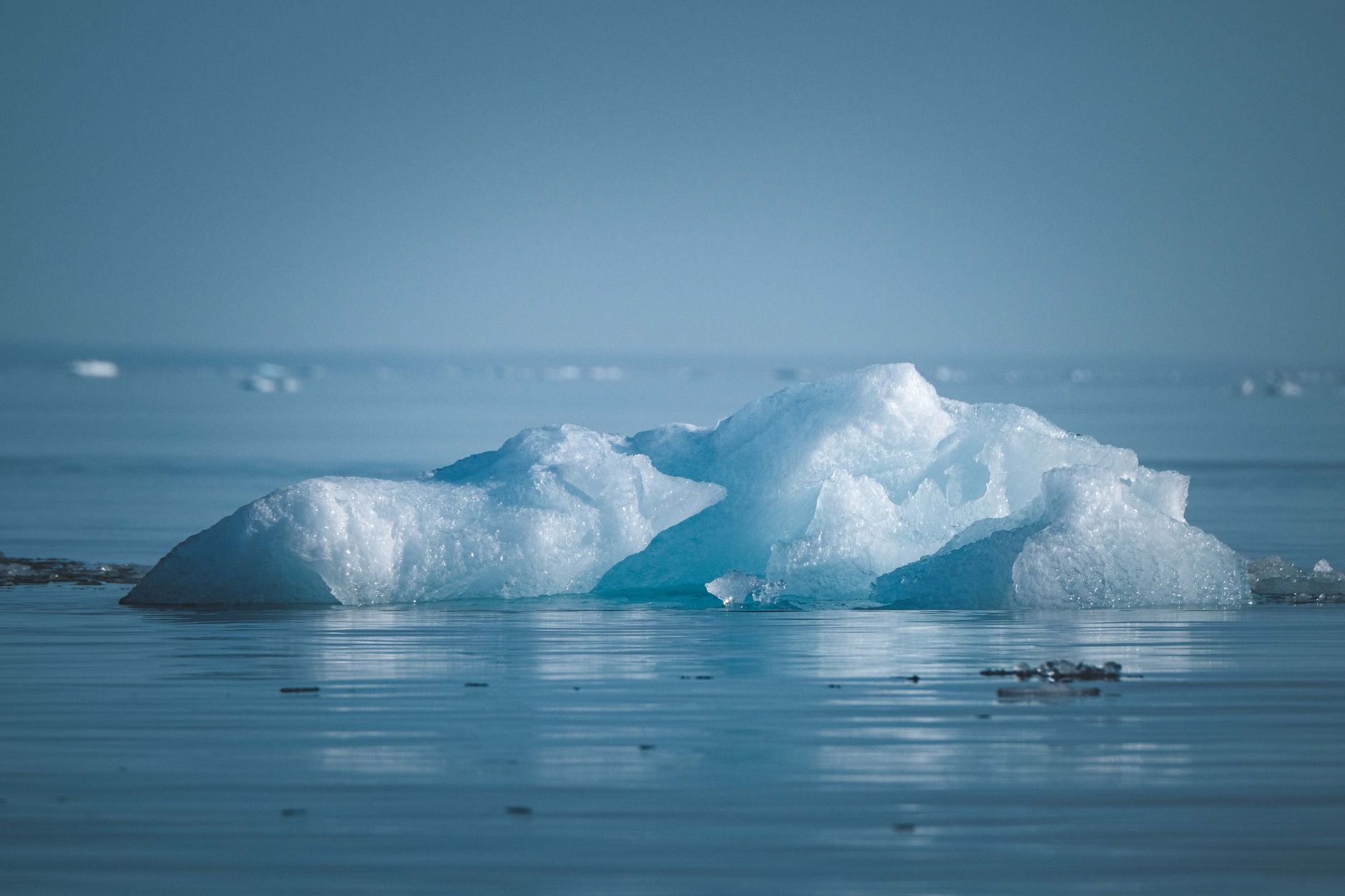 A serene iceberg floating in arctic waters, showcasing the natural beauty of ice formations.
